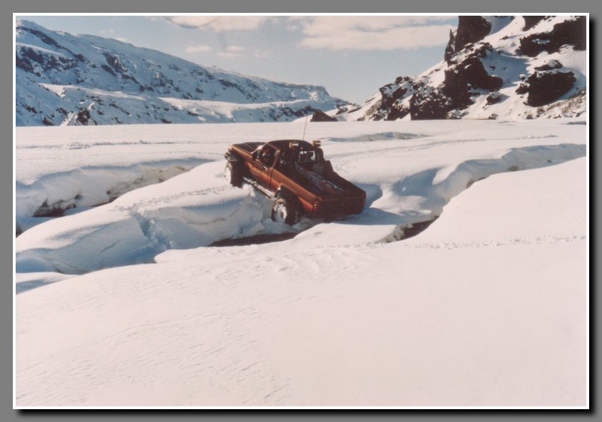 Crossing Krossa river (Cross River), the final and the largest river to cross before reaching our destination. Aegir is actually backing down and making a left turn to be able to follow the river down stream. The snow banks are too tall to exit in this area.